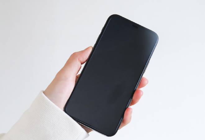 スマホを持つ女性の手元。